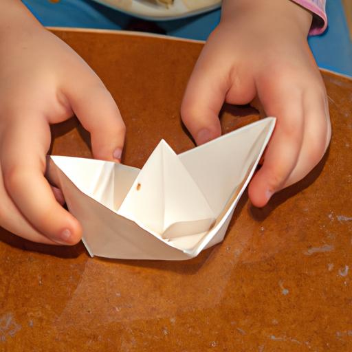 A child's creativity at work making a paper boat